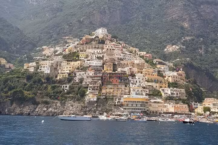 A breathtaking view of Positano's colorful cliffside buildings from the sea on an Amalfi Coast private boat tour.