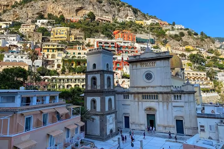 View of Positano with colorful hillside buildings and historic church on a small group tour from Sorrento.