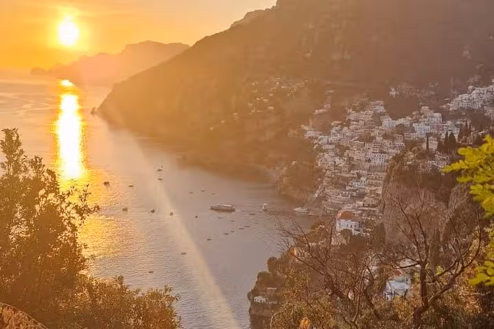 Stunning sunset over Positano coastline, highlighting the beauty of an Amalfi Coast private tour from Naples.
