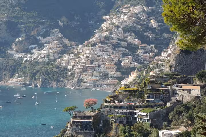Scenic view of Positano with colorful cliffside houses, part of the Amalfi Coast transfer experience to Rome.
