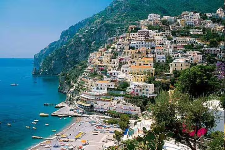 Colorful cliffside houses and lively beach in Positano, a highlight of a private full day tour along the Amalfi Coast
