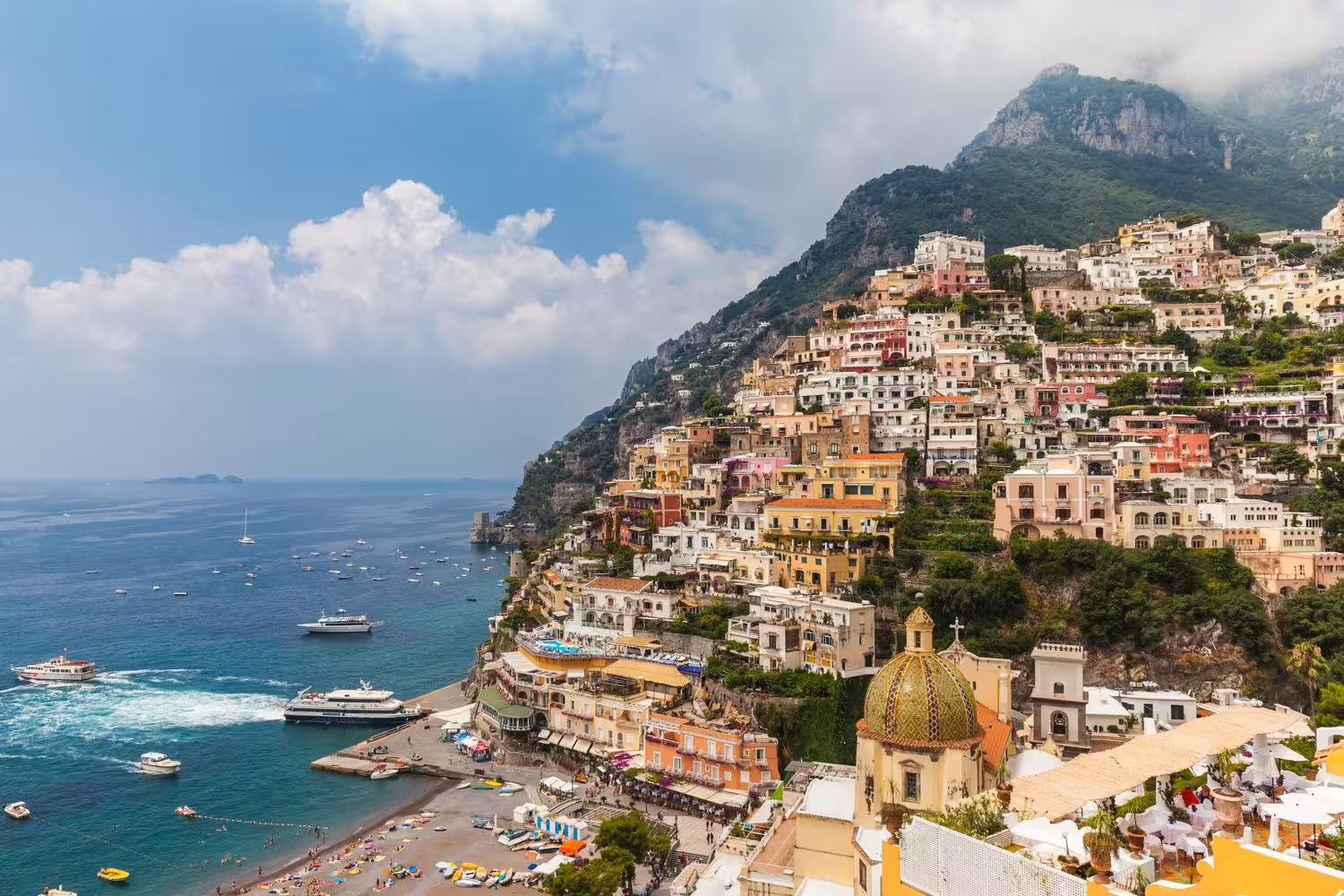 Positano coastline panorama with beach and boats, iconic view on Sorrento Positano Amalfi Ravello group tour