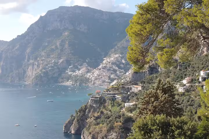 Scenic view of Positano's stunning coastline, highlighting picturesque cliffs and turquoise sea for travelers.