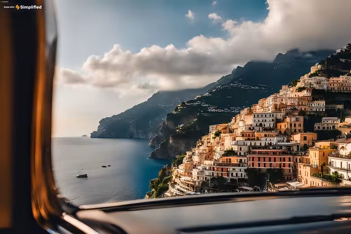 Scenic view of Positano's colorful cliffside homes from a car window on an Amalfi Coast private tour.