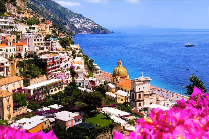 Scenic view of Positano's colorful cliffside houses and azure sea on a private guided Amalfi Coast day trip from Sorrento.