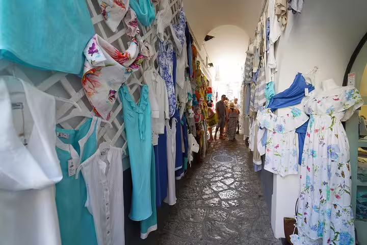 Colorful clothing shops line the narrow streets of Positano on the Amalfi Coast tour from Sorrento.