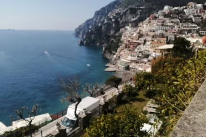 Panoramic view of Positano’s terraced houses over the Tyrrhenian Sea along the scenic Amalfi Coast shared tour route