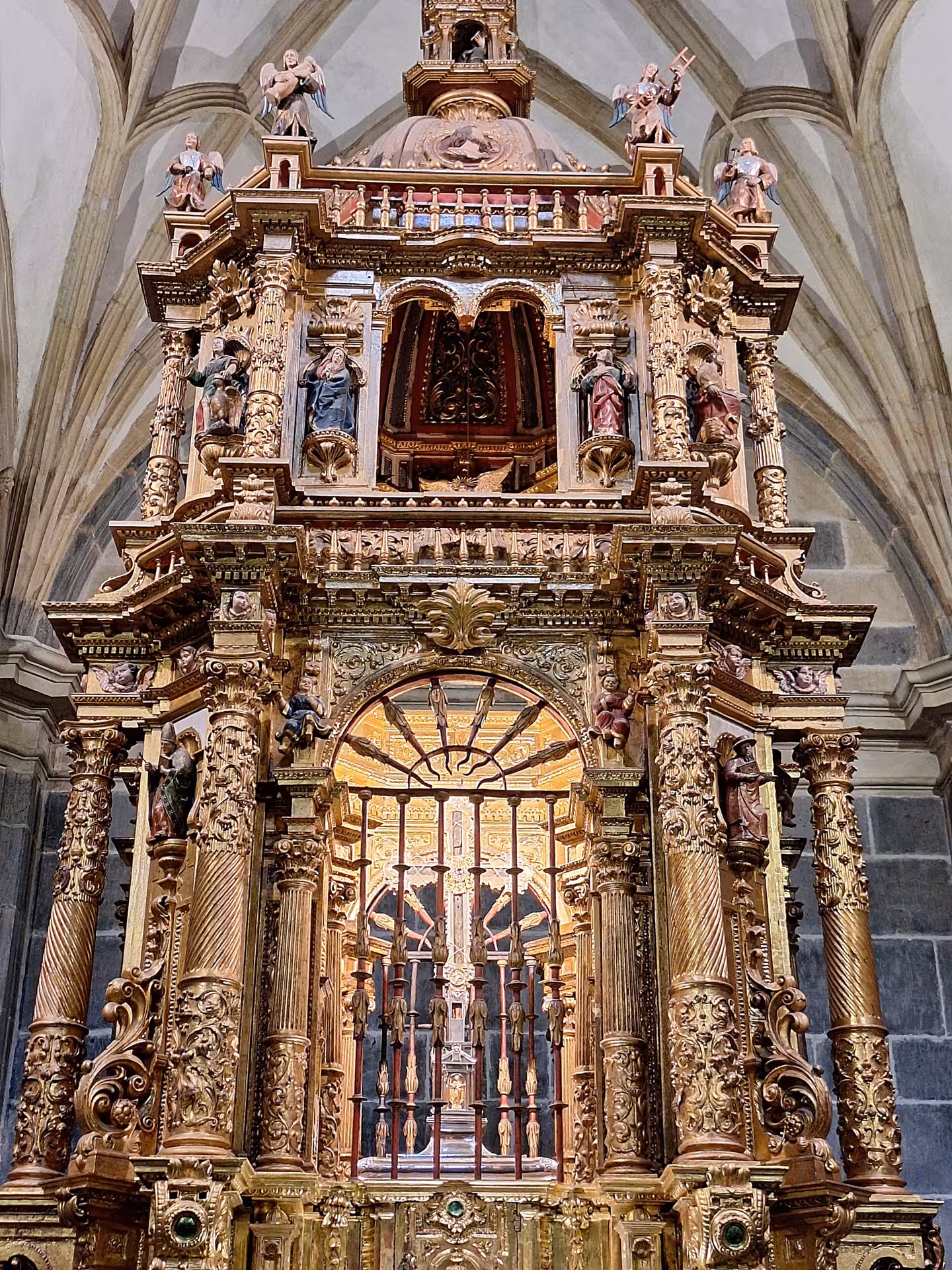 Ornate, gilded altar in a Potes church, showcasing intricate craftsmanship on a Picos de Europa tour.