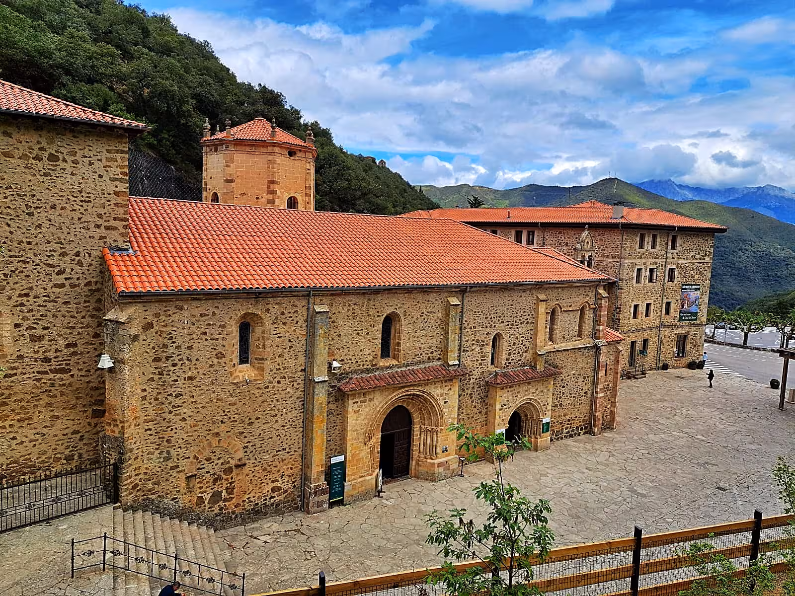 Historic stone building in Potes with mountain backdrop, ideal for small group tours from Santander.