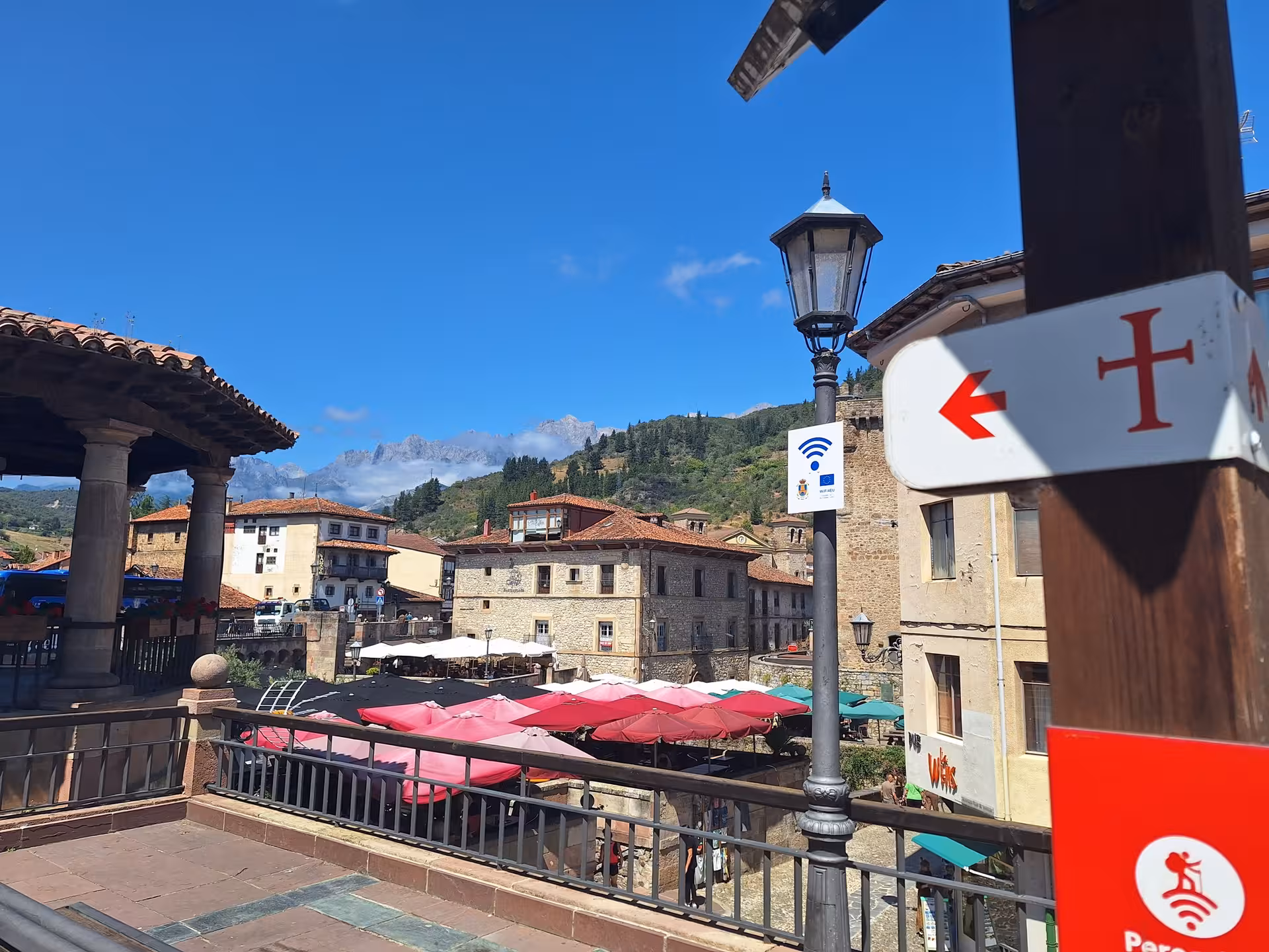 Charming Potes village square with scenic mountain backdrop on Picos de Europa guided tour from Santander.