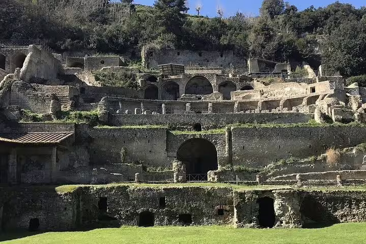 Terraced Roman ruins and stone arches of the ancient amphitheater in Pozzuoli on a private tour from Naples to Phlegraean Fields