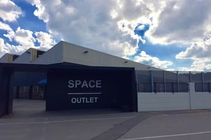 Entrance of Space Prada Outlet near Florence, ideal stop on private chauffeur shopping tour to The Mall luxury outlets