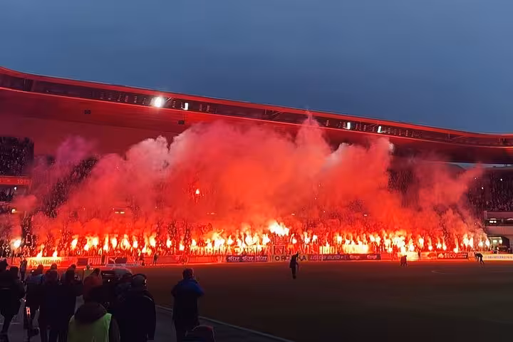 Red flares and smoke fill the stands at a Prague derby, Slavia or Sparta game with a local matchday experience