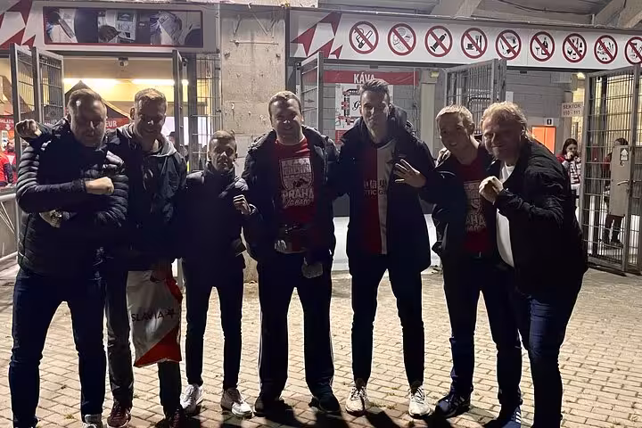 Fans pose outside Prague stadium before Slavia or Sparta match on a local-hosted football experience tour