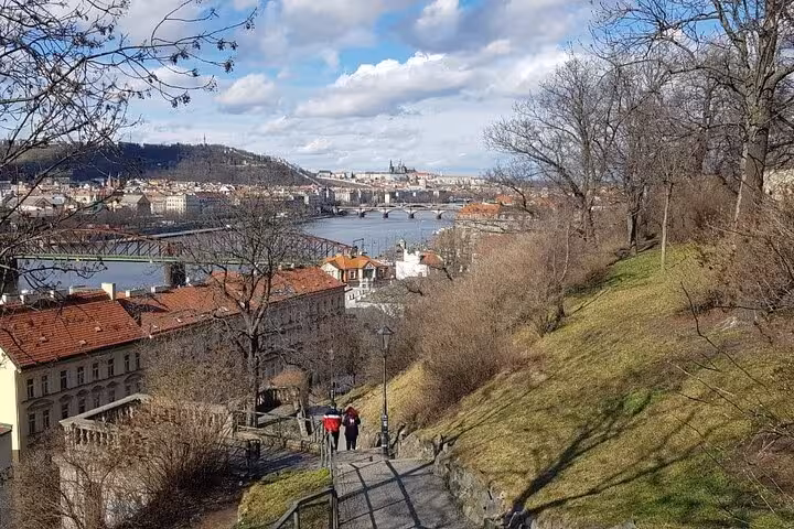 Scenic Prague hillside path overlooking Vltava River and bridges on a small-group day trip from Vienna