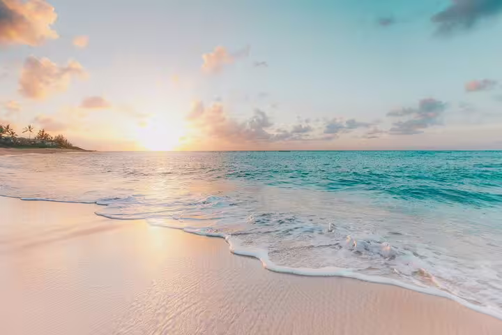 Breathtaking sunrise over the pristine beach of La Digue, perfect for the Praslin & La Digue day trip experience.