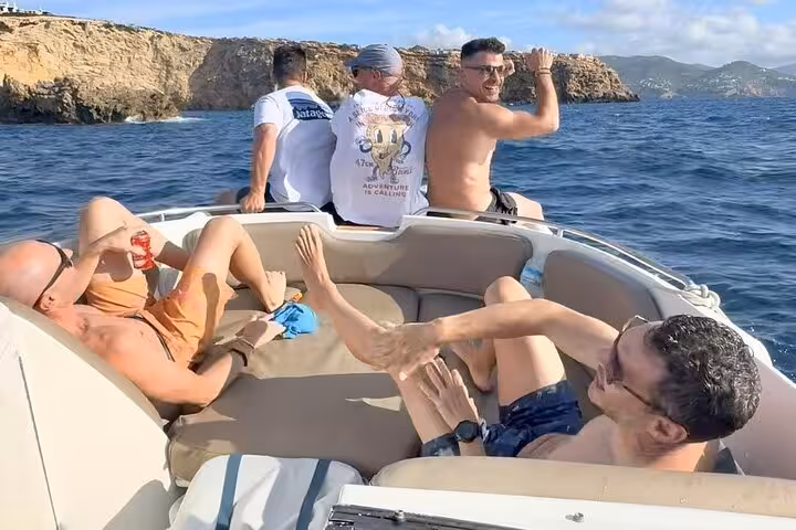 Group enjoying a boat tour near Cala Comte's stunning coastline, part of the Premium route Cala Bassa and Magic Cove.