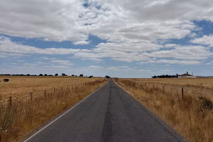Scenic rural highway under cloudy sky, ideal for premium private transfer and long-distance chauffeur service