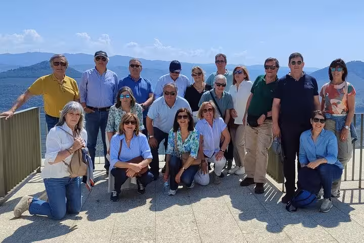 Premium Douro Valley tour group photo at panoramic viewpoint overlooking vineyards and river in northern Portugal