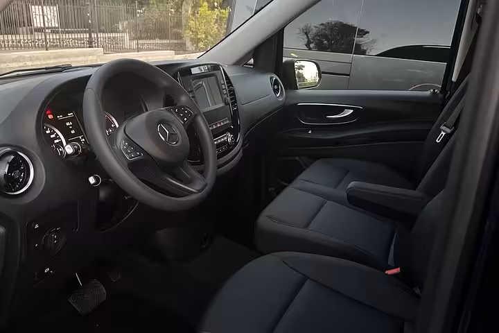 Interior view of premium Mercedes van, showcasing spacious leather seating and modern dashboard for Rome to Amalfi Coast transfer.