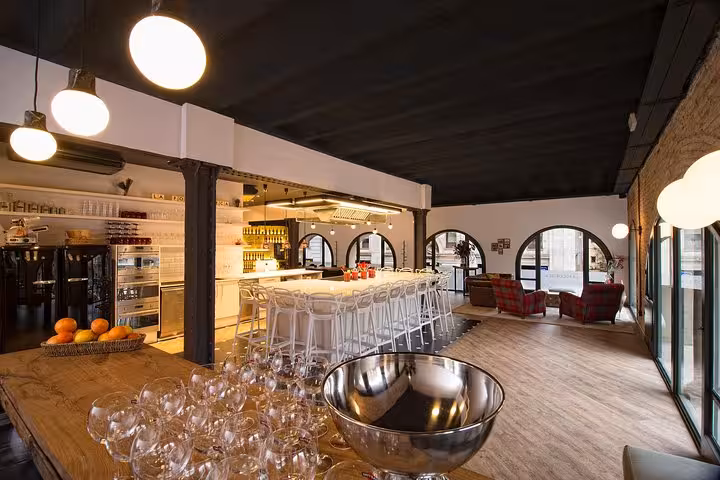 Elegant designer loft with a modern kitchen setup, perfect for a premium Spanish cooking class experience.