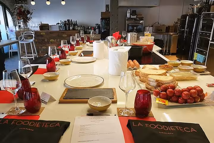 Elegant kitchen setup for Spanish cooking class featuring wine glasses, fresh ingredients, and stylish decor.