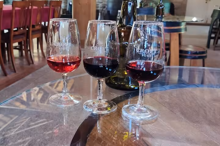 Three glasses of red wine on a table at a Portuguese winery, part of a Premium Tour tasting experience