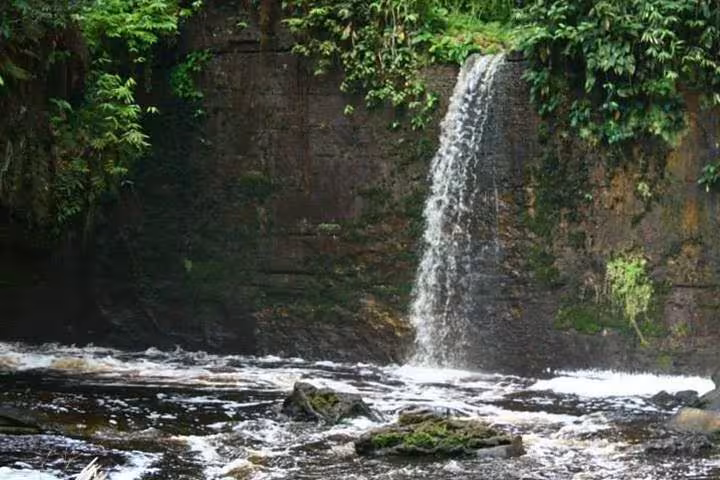 Amazon rainforest waterfall in Presidente Figueiredo, Manaus day tour stop with natural pool and lush jungle