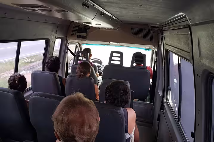 Passengers riding a tour van from Manaus to Presidente Figueiredo for Amazon waterfalls day trip and jungle adventure