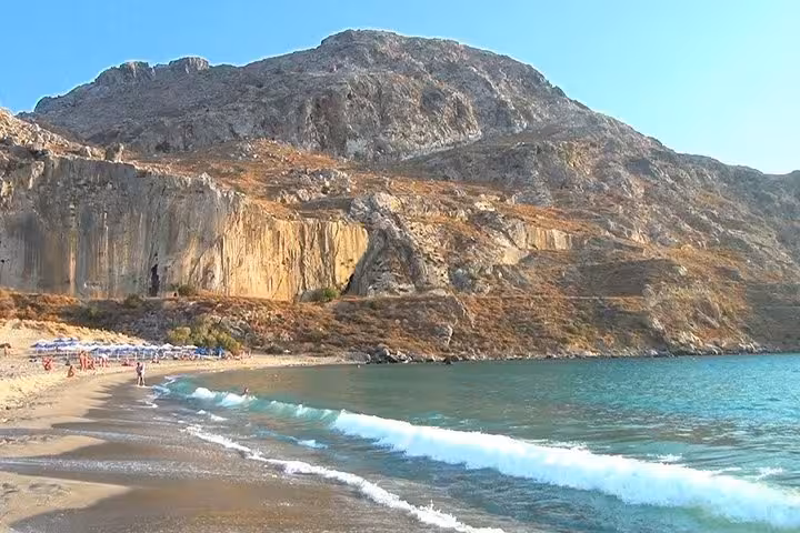 Waves on Preveli Palm Beach beneath rugged cliffs, a popular south Crete excursion from Rethymno