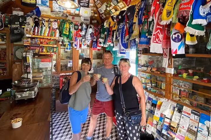 Guests toast local poncha in a traditional Madeira bar stop on a private 4x4 shore excursion adventure