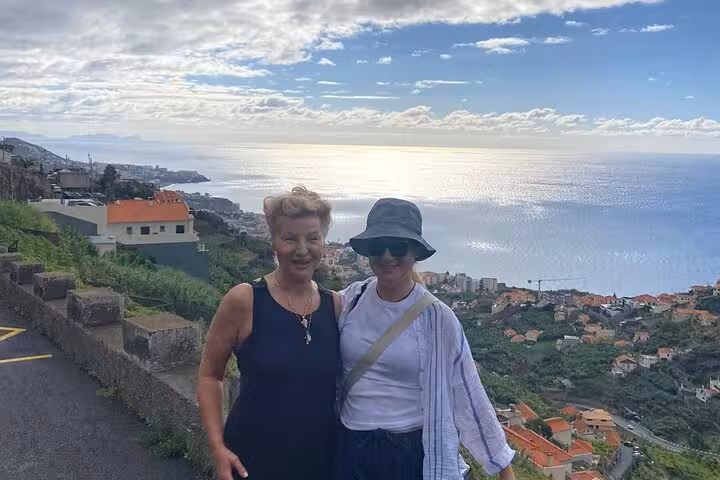 Travelers at a coastal lookout over Funchal and the Atlantic on a private 4x4 shore excursion in Madeira