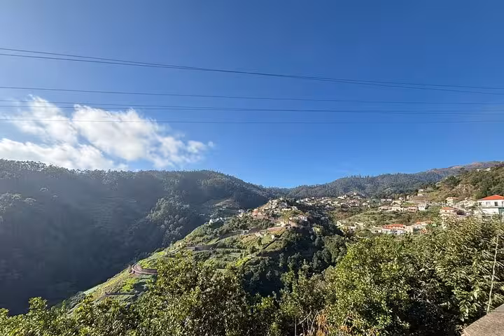 Panoramic green mountain valley and hillside villages under blue sky, view from a private 4x4 shore excursion tour
