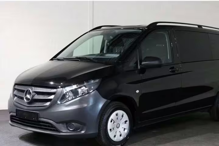 Luxurious black Mercedes van for private airport transfer to Lisbon city center, offering comfort and convenience.