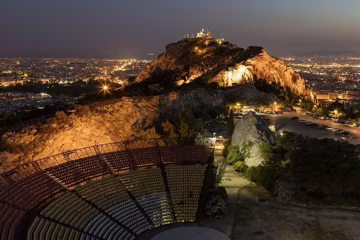 Stunning view of illuminated Lycabettus Hill and ancient amphitheater in Athens, perfect for a private night tour experience.