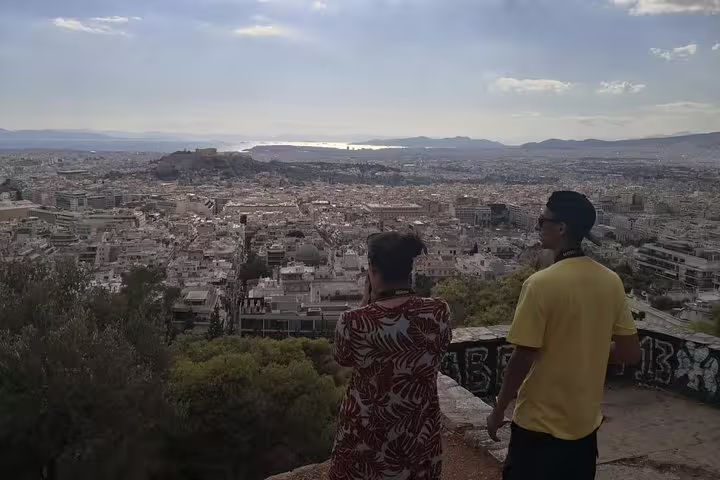 Travelers enjoy panoramic Athens city views on a private full-day tour, overlooking the Acropolis and coast