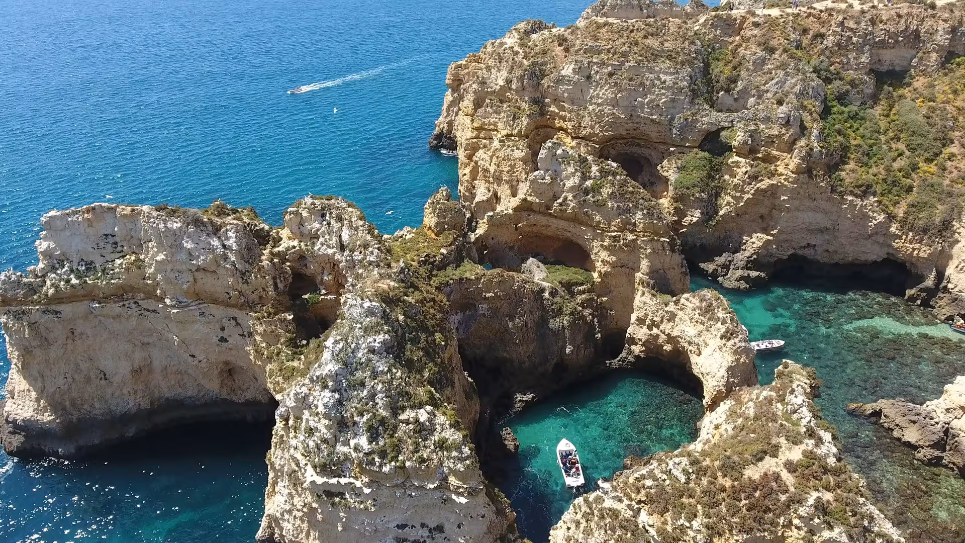 Aerial view of private boat cruise at Ponta da Piedade, Lagos, with turquoise coves and swim stop