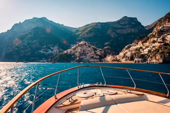 View from a private boat tour showcasing the stunning Amalfi Coast with vibrant seaside cliffs and blue waters.