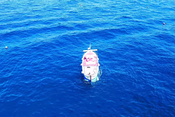 Aerial view of private boat on Capri sea, ideal for a 2-hour sightseeing tour with swimming stops