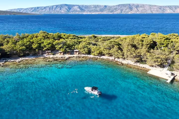 Aerial view of private boat tour in Croatia’s crystal-clear bay, island escape with swimming in the Adriatic