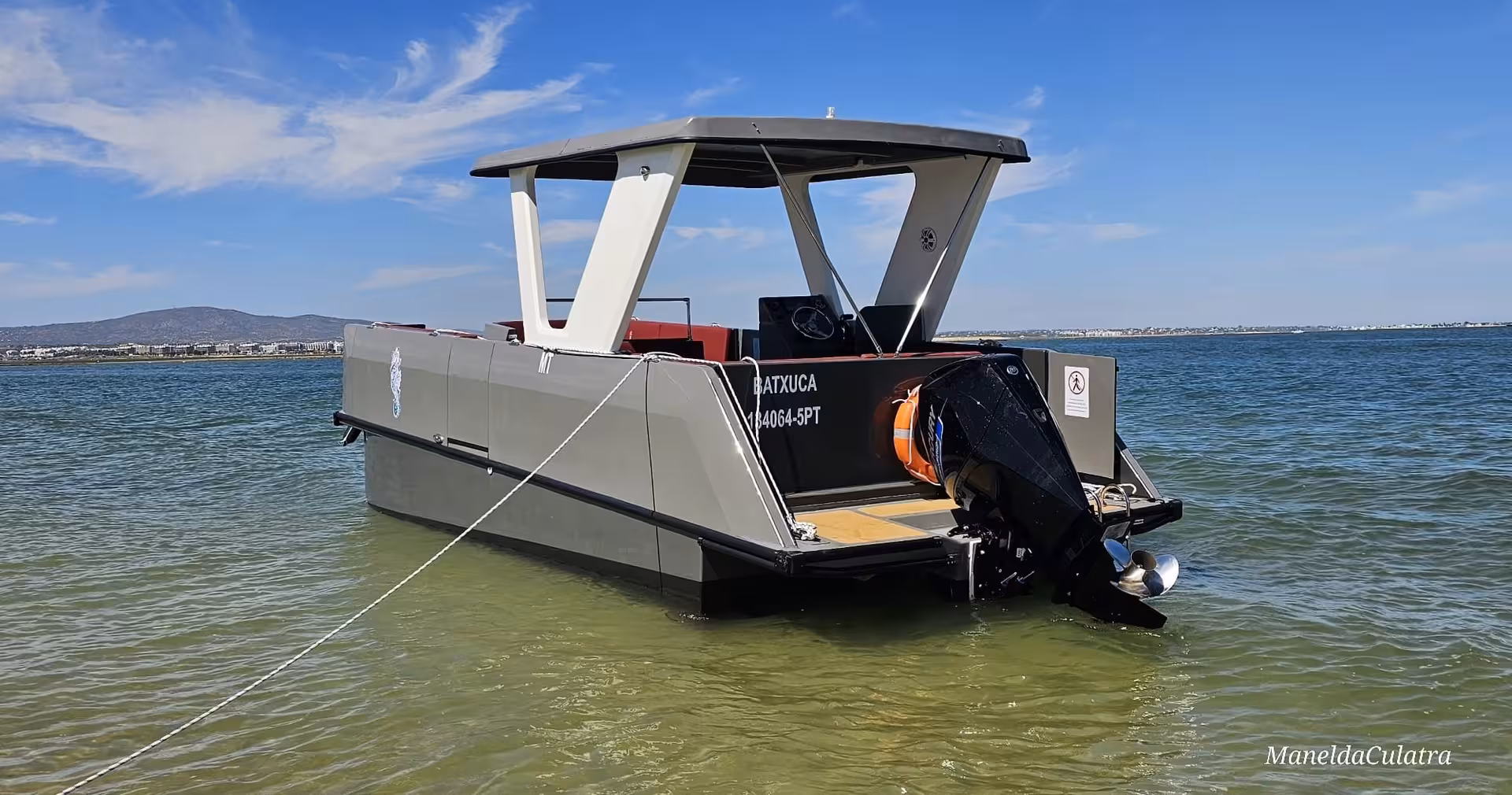 Modern boat anchored in Ria Formosa lagoon, perfect for private tours exploring Algarve's stunning coastal scenery.