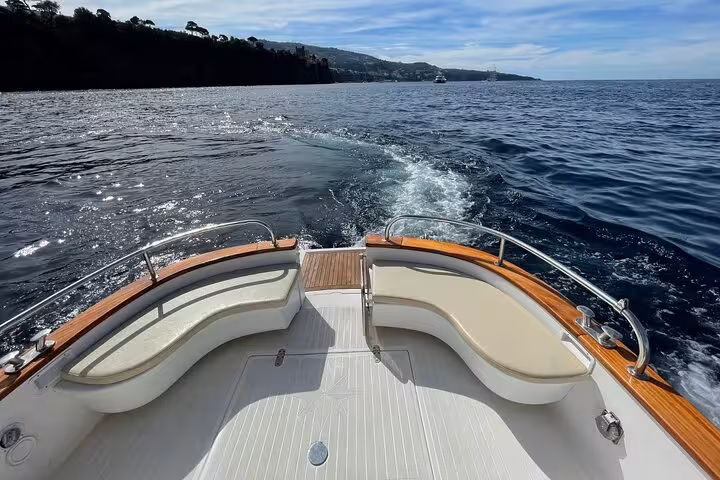 Discover the beauty of a private boat journey from Sorrento to Capri, showcasing panoramic ocean views.