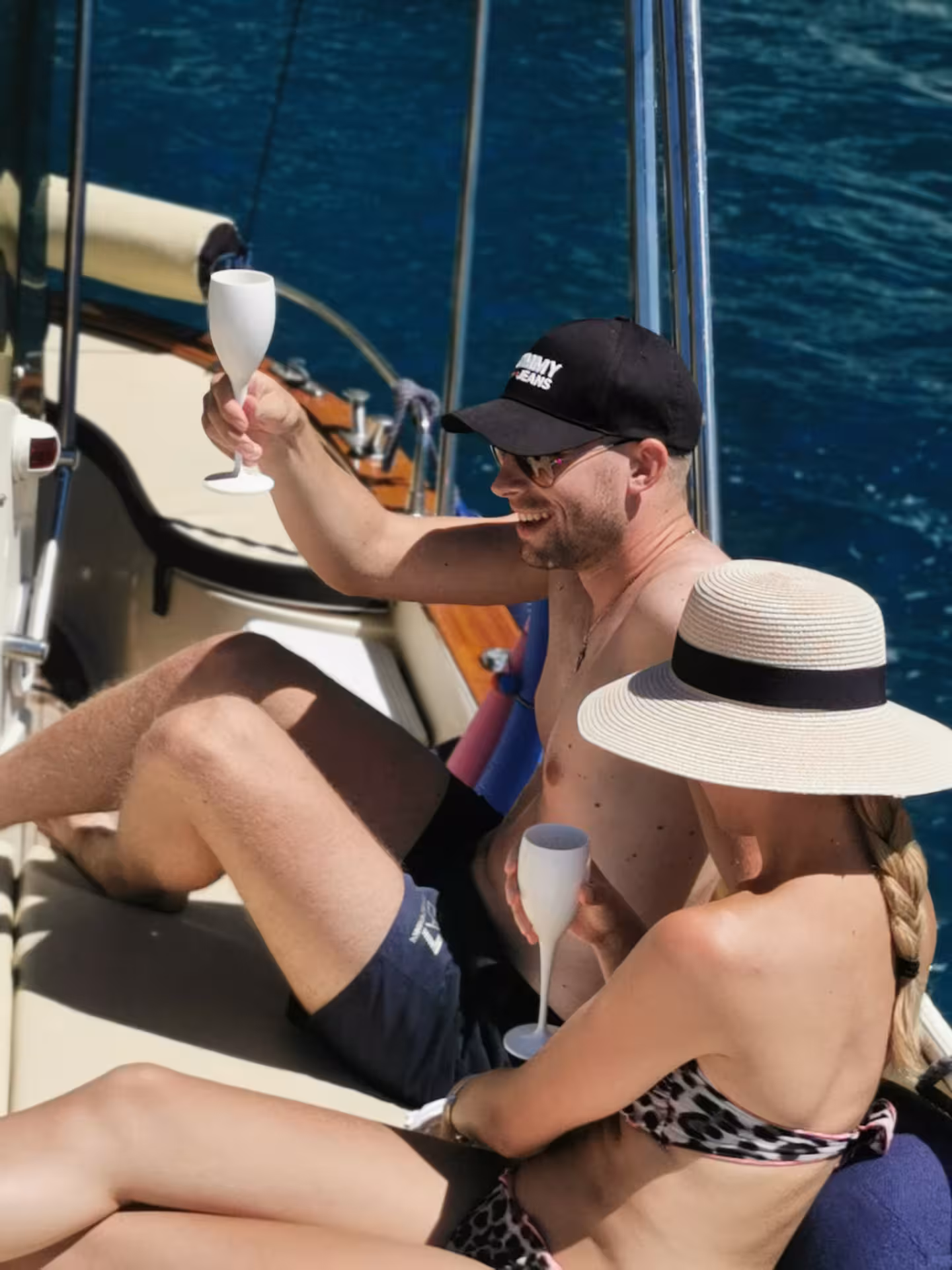 Couple enjoying champagne on a private boat tour, cruising from Sorrento to Positano along the Amalfi Coast.