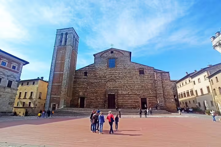 Travelers in Piazza Grande admiring Montepulciano’s stone cathedral on a private Brunello and Nobile wine tour in Tuscany