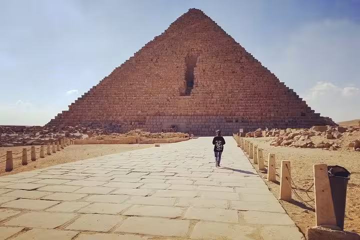 Traveler walking the stone path to the Great Pyramid of Giza on a private Cairo day tour from Hurghada
