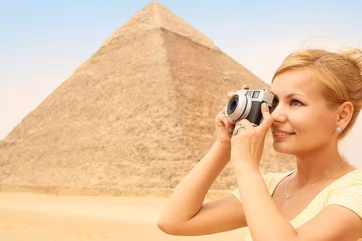 Traveler photographing the Great Pyramid of Giza on a private Cairo day tour from Hurghada Makadi Bay Soma Bay El Gouna
