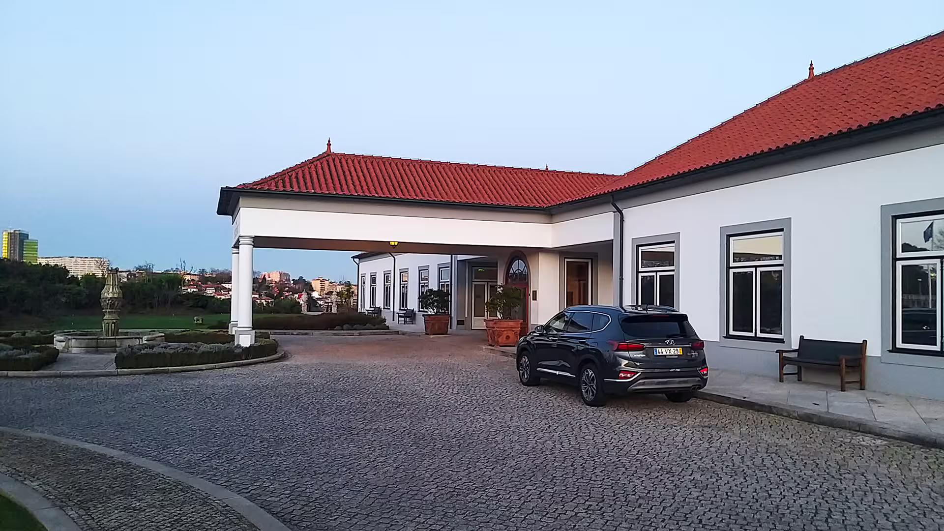 Private car at a hotel entrance in Porto, offering seamless transfers to Povoa de Varzim.