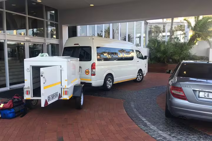 Private chauffeur service van parked at a Cape Town hotel entrance, ready for a full-day city tour.