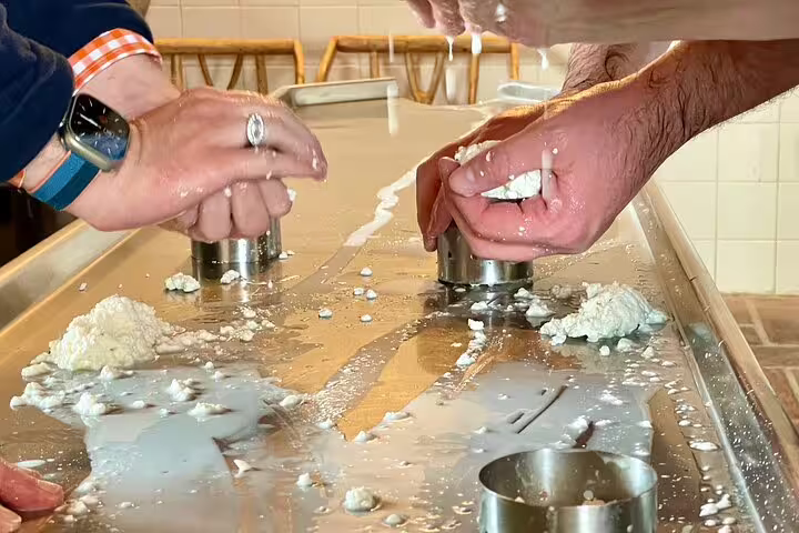 Hands crafting cheese in Azeitão workshop during private tour with wine tasting and Sesimbra exploration experience.