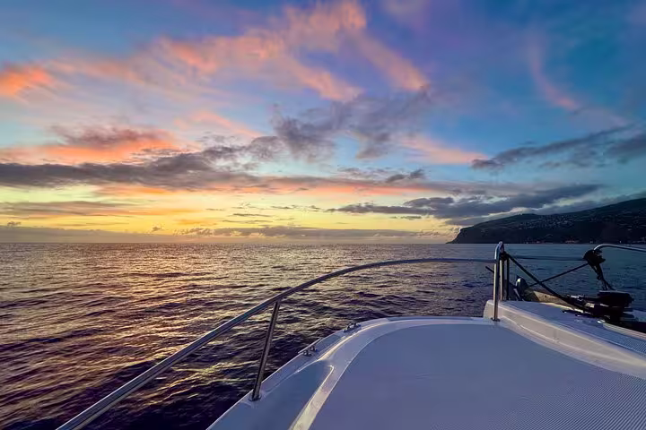 View from a private cruise boat at sunset with colorful sky, offering a tranquil setting for afternoon tea and coffee.